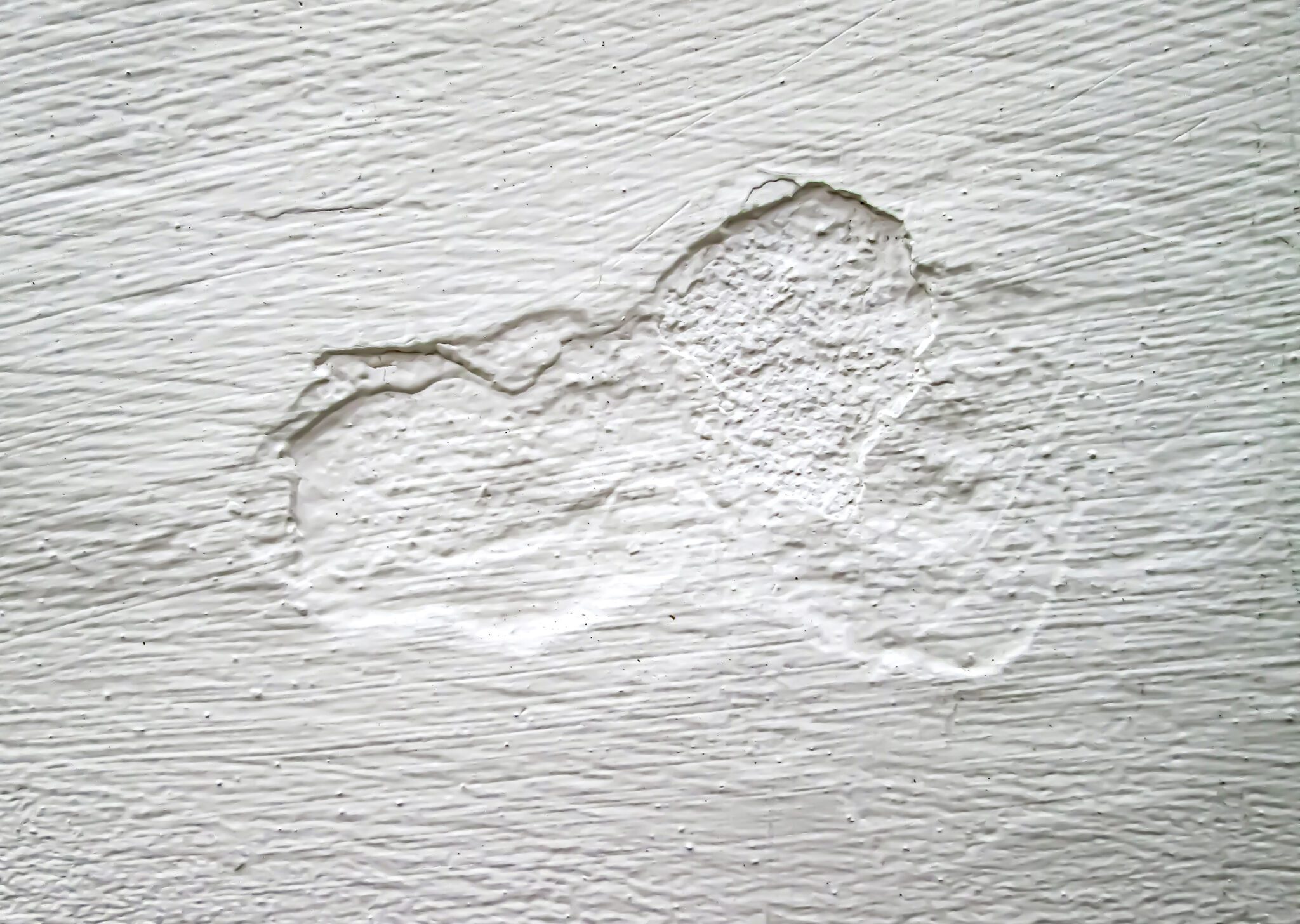 The texture of the old white wall. Removal from mechanical damage. Stock photo for retro overlay effects.