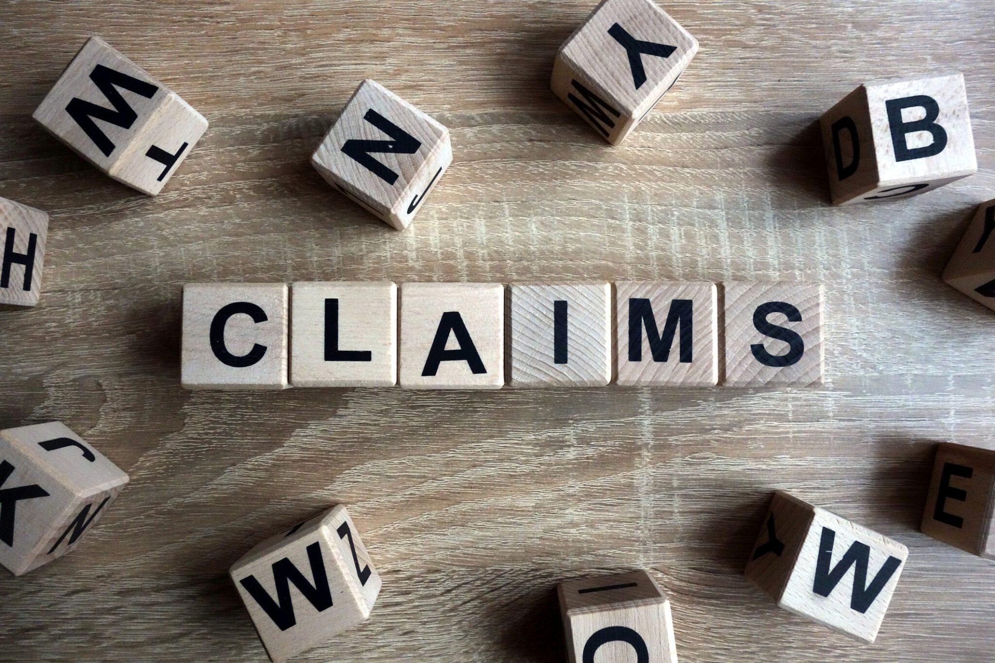 Claims word from wooden blocks on desk